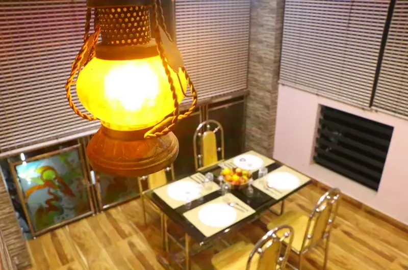 Warmly lit bedroom corner featuring an elegant hanging pendant lamp