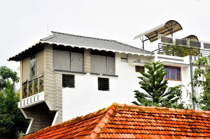 Side angle view of Mary Land Homestay structure with traditional roofing details
