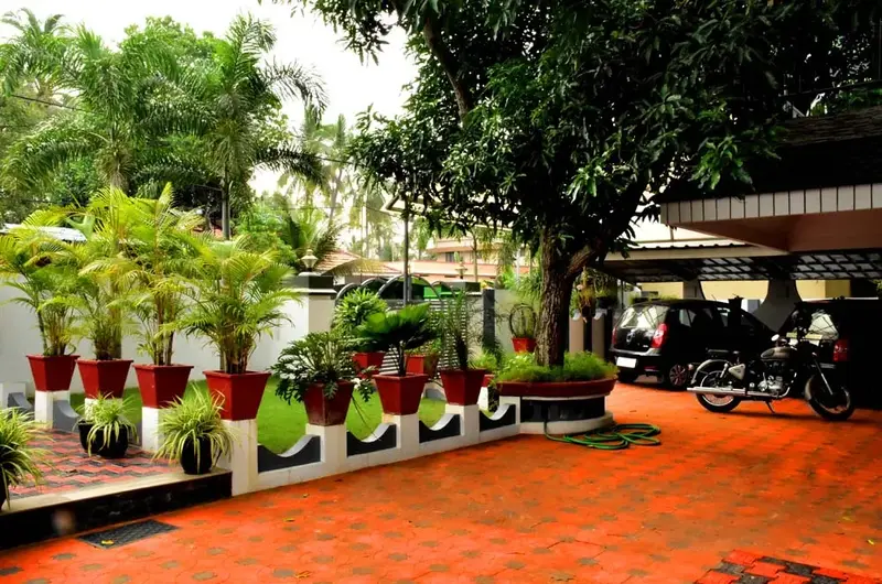 Paved entrance driveway and parking area at Mary Land Homestay in Kovalam