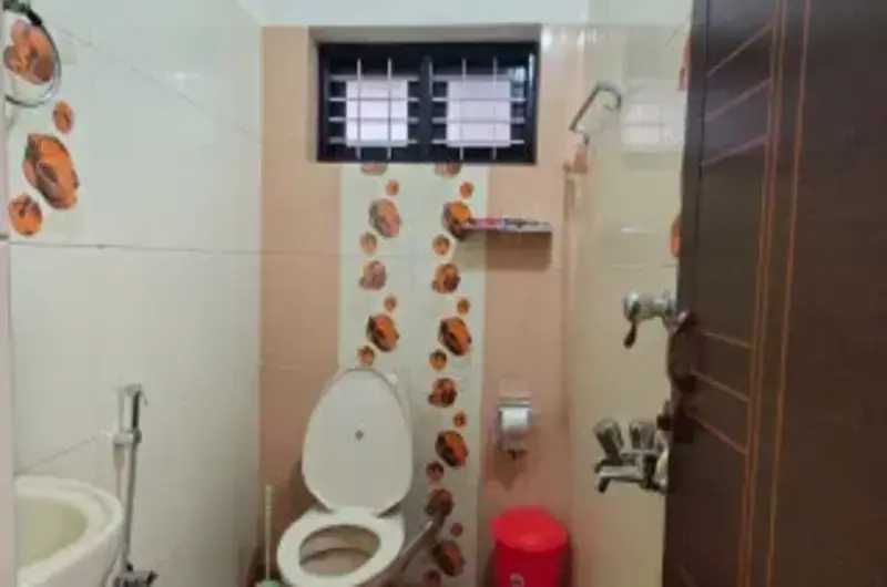 Clean modern bathroom interior with premium fixtures and neutral wall tiles at Therickal Homes.
