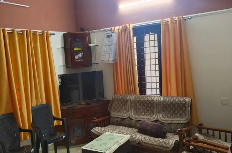 Cozy homestay living room lounge with comfortable sofa seating at Therickal Homes Kovalam.