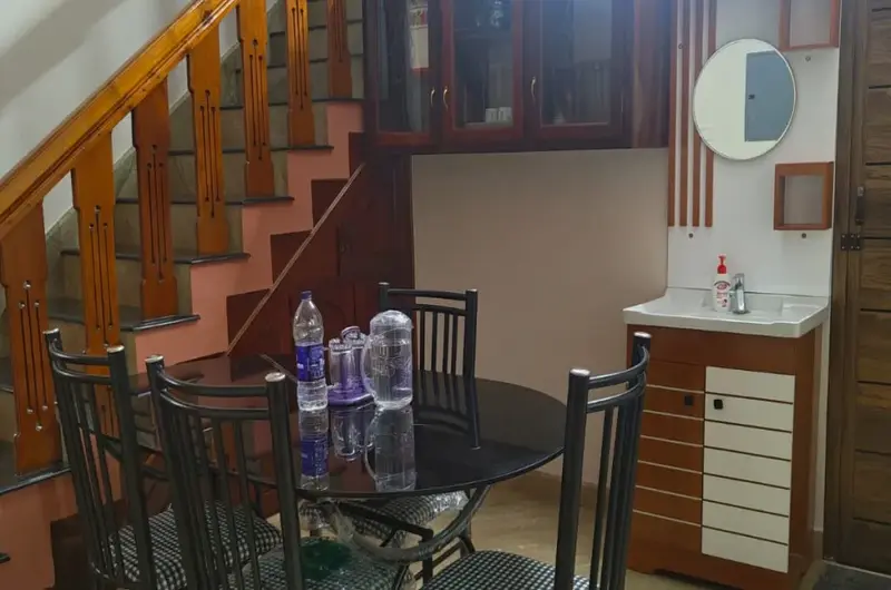 Elegant indoor dining room area and staircase setup at Therickal Homes Homestay.