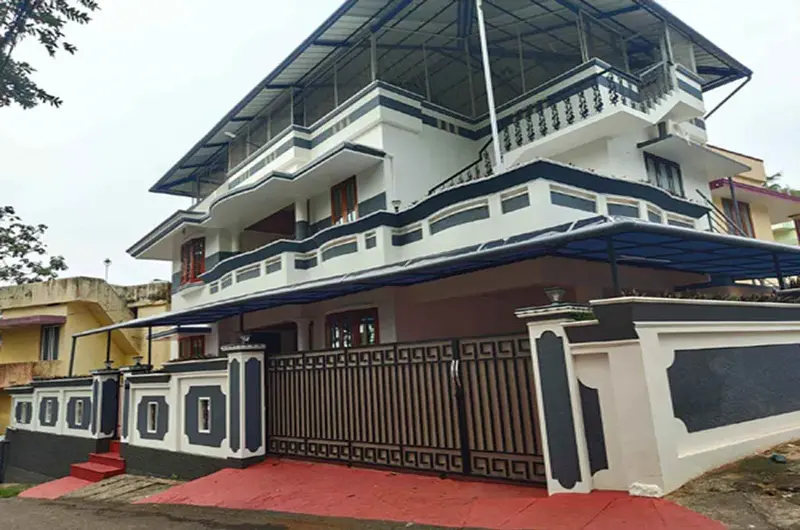 Modern building architecture and gated exterior facade of Therickal Homes Homestay Kovalam.