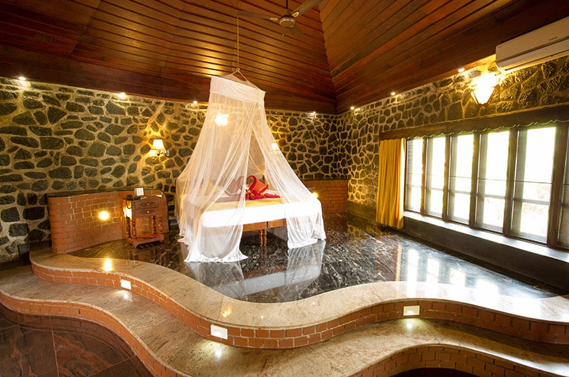 Therapy room with wooden massage table at Somatheeram Ayurvedic Health Resort Kovalam