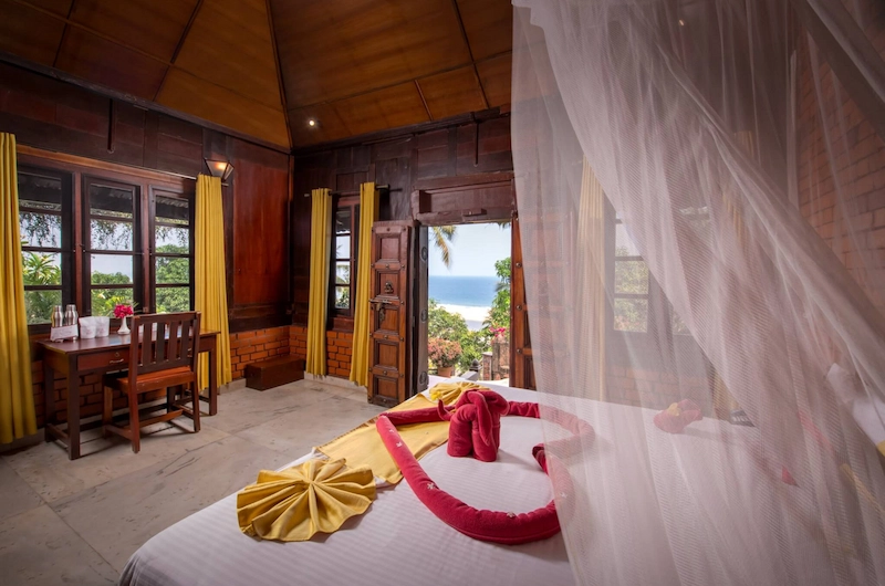 Spacious resort room interior with canopy bed at Somatheeram Ayurvedic Health Resort