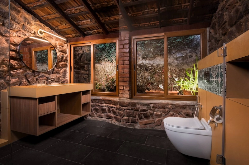 Spacious bathroom interior with stone walls at Somatheeram Ayurvedic Health Resort