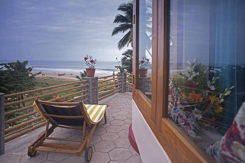 Wooden deck with sun lounger overlooking Kovalam beach at Somatheeram Ayurvedic Health Resort