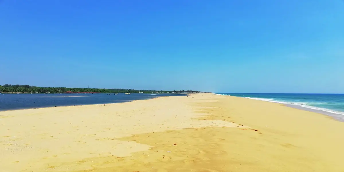 A panoramic view of the sandy Pozhiyoor coastline and beach near Poovar, Thiruvananthapuram, Kerala.