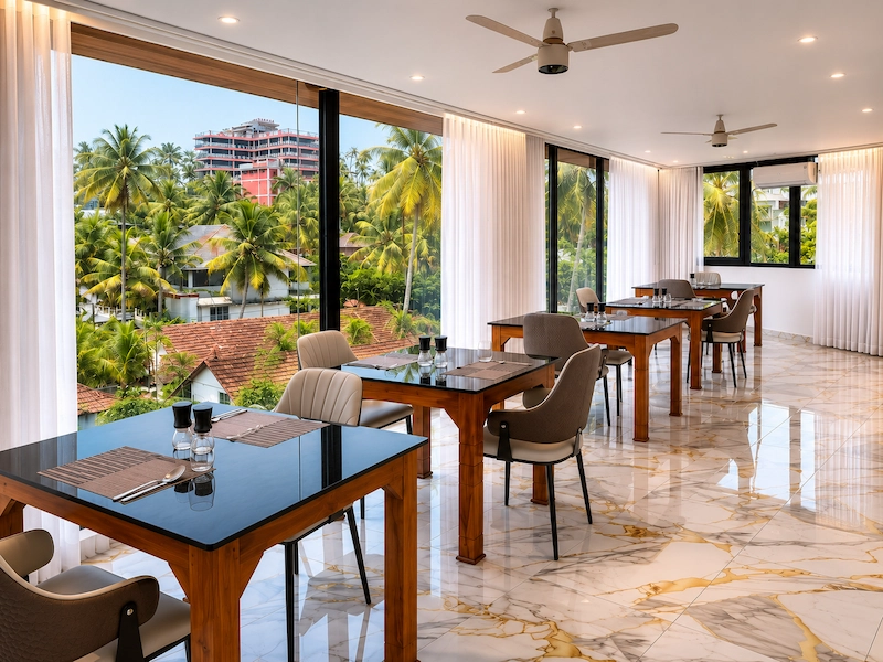 Clean interior dining layout at Hotel Materhorn breakfast restaurant near Light House Beach Kovalam