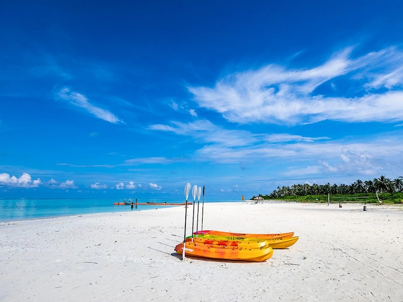 Scenic vista of vibrant turquoise ocean waters and blue sky at Lakshadweep beach